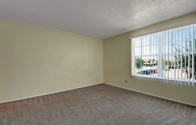 an empty living room with a large window