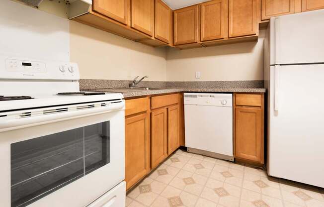 A kitchen with a white stove and white refrigerator.