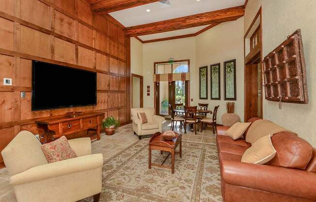 a living room filled with furniture and a flat screen tv  at Hacienda Club, Jacksonville, FL, 32256