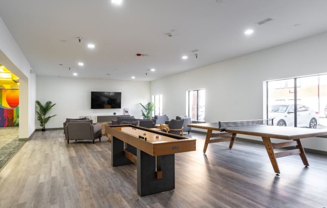 an open living room with a pool table and a television