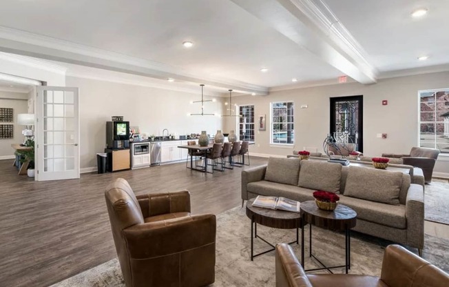 a living room with couches and chairs and a kitchen  at Arlo Luxury homes Apartments, Little Rock, Arkansas