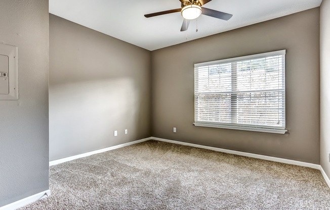 Bedroom with neutral paint, carpet, and ceiling fan