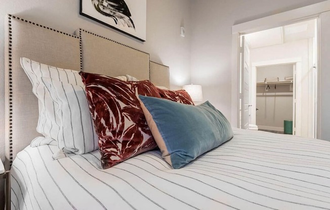 a bedroom with a large bed with pillows on it