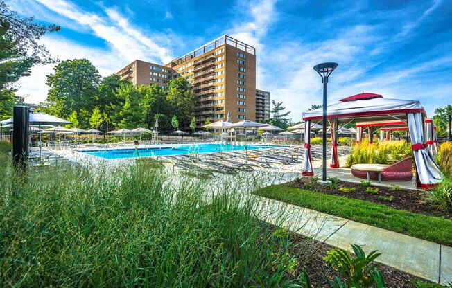 A pool area with a red and white canopy structure.