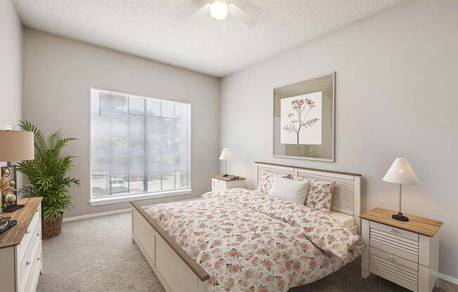 A bedroom with a large bed and a ceiling fan.