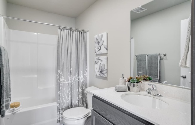 Full Bathroom with grey cabinets and full sized tub and shower combination. at Altitude, Washington