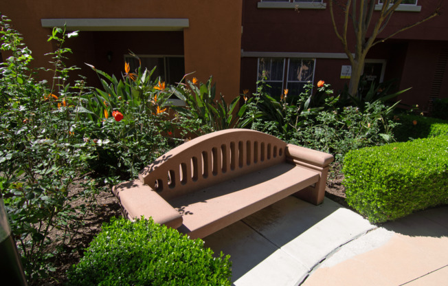 A bench sits in the middle of a garden.
