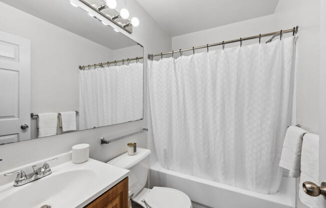 a bathroom with a sink toilet and a shower