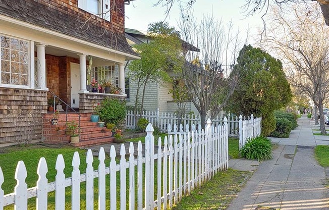 Sidewalk with white fence and homes  at 215 BAYVIEW APARTMENTS, San Rafael, CA