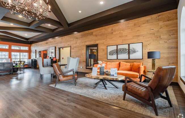 A living room with a brown leather chair and a wooden floor.