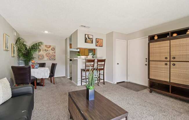 A living room with a couch, chairs, and a coffee table.