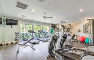 Stone Canyon Apartments Equipped Fitness Center with Various Cardio and Weight Machines at Stone Canyon Apartments, California