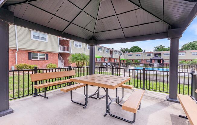 an empty park bench next to a building