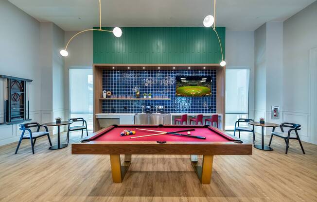 a pool table in a room with a bar and tables