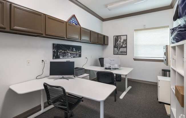 an office with two desks and a computer