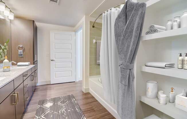 a bathroom with a shower and a sink and a rug