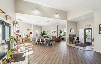 a living room and dining room with a table and chairs