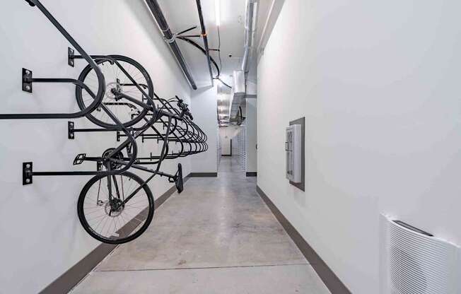 A hallway with bicycles hanging on the wall.
