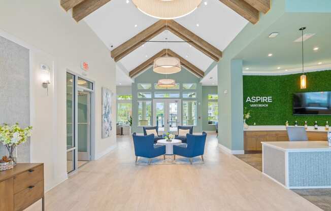 a dining room with blue chairs and a table in the middle