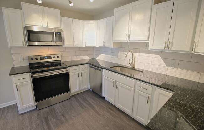 a kitchen with white cabinets at Viceroy Apartments, North Carolina, 27707