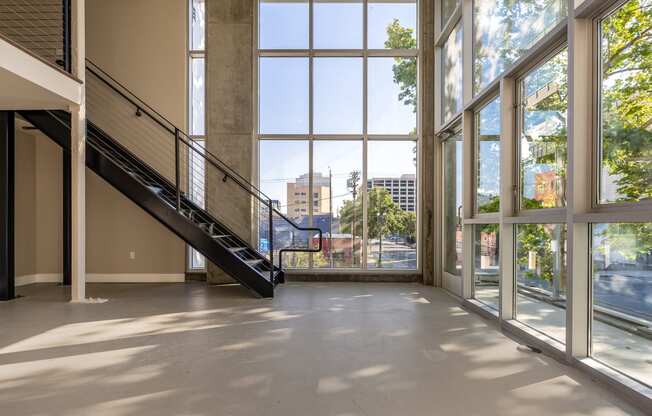 a large open space with large windows and a staircase