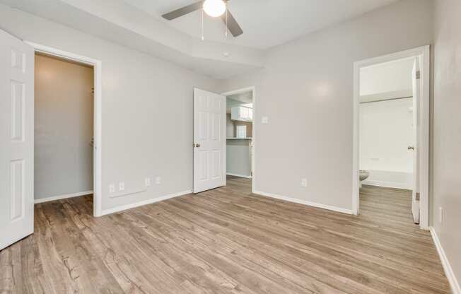 an empty living room with a wood floor and a ceiling fan at Foxborough Apartments, Irving, TX, Texas, 75061