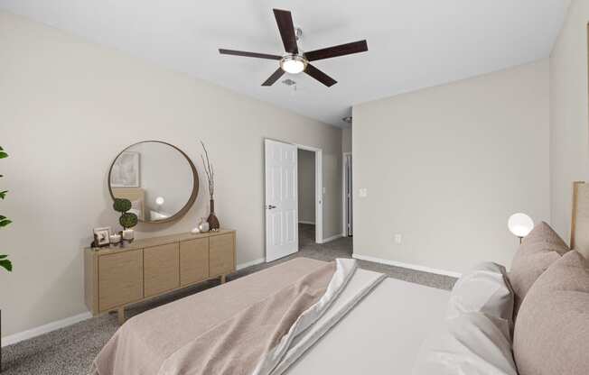 a bedroom with a large bed and a ceiling fan