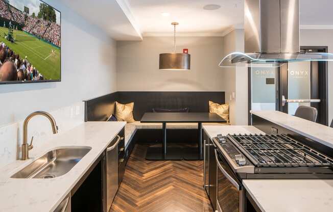 Gas stove and stainless steel sink in clubhouse kitchen - Onyx Edina