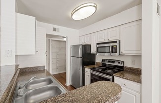 a kitchen with granite countertops and white cabinetsat Stonebriar Woods Apartments, Kansas, 66213