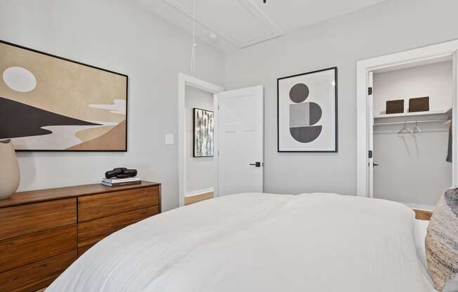 a bedroom with a walk-in closet and model furniture at Sanctuary at Indian Creek rental homes in Madison, AL