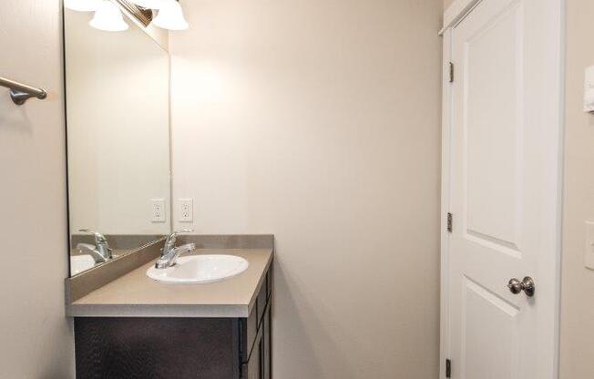 a bathroom with a toilet and a sink and a mirror at Madison Park, Bozeman, 59718