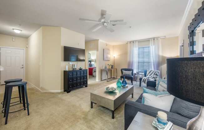 an open living room and dining room with a ceiling fan