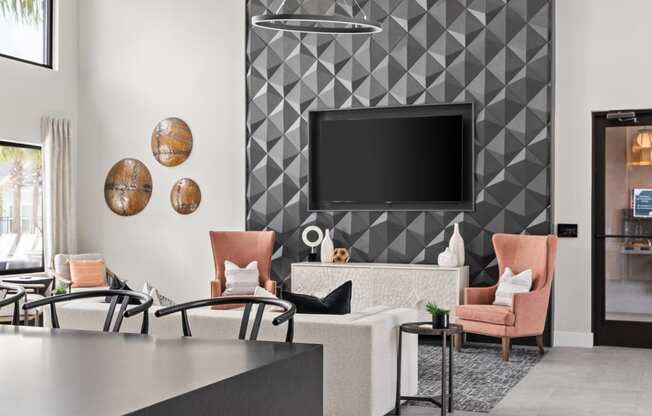 a living room with a tv and a table and chairs at The Sophia, Venice, FL, 34275