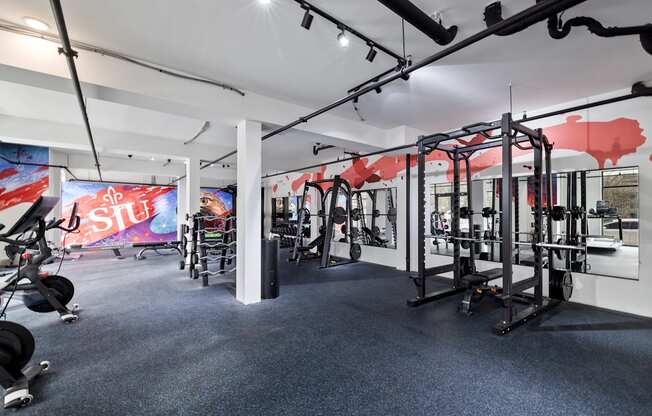 a gym with weights machines and ads on the wall