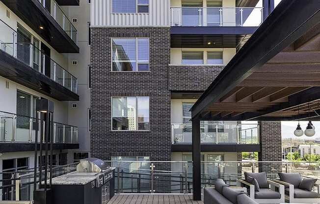 a covered outdoor patio by a building at Lotus Republic Apartments for rent in Downtown Salt Lake City, Utah Lotus Republic Apartments for rent in Downtown Salt Lake City, Utah