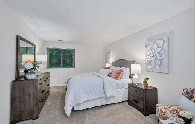 a bedroom with a large bed and two dressers