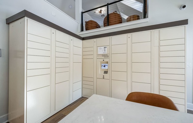 A room with a white bed and a brown chair.