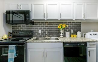 a stove top oven sitting inside of a kitchen