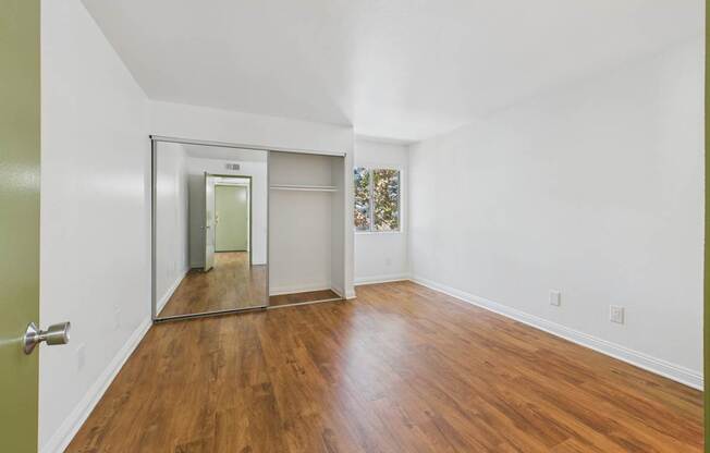 A room with wooden floors and a white ceiling.