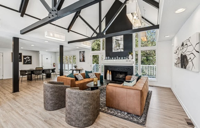 A modern living room with a fireplace and a large window.
