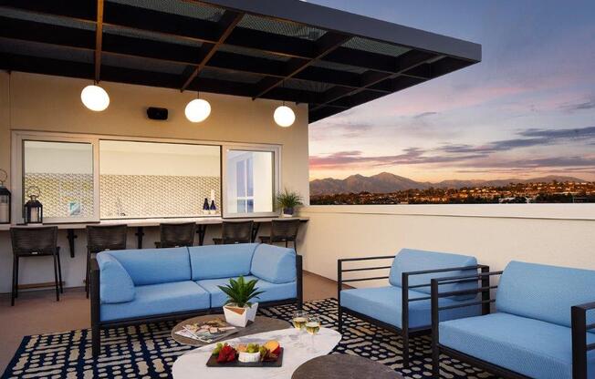 a living room with blue couches and a table