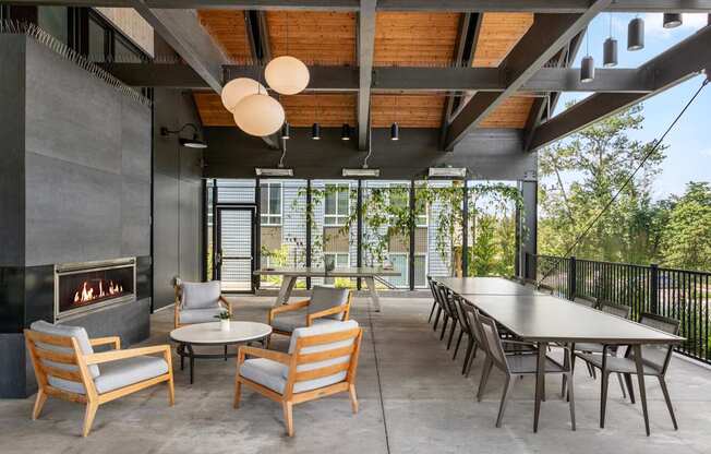 A modern patio with a fireplace and seating area.