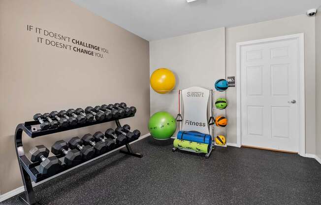 24-hour fitness center at cardio machines and weights at Woodland Villa Apartments in Westland, MI.