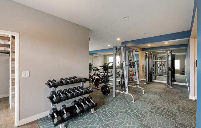 Fitness center with weights  at OceanAire Apartment Homes, Pacifica
