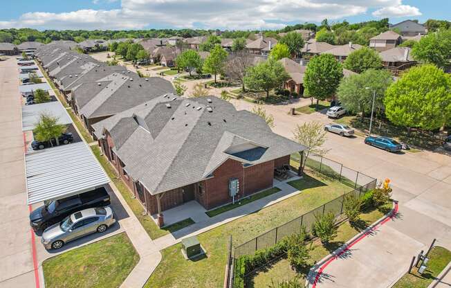 A row of houses with a car parked in front of each.