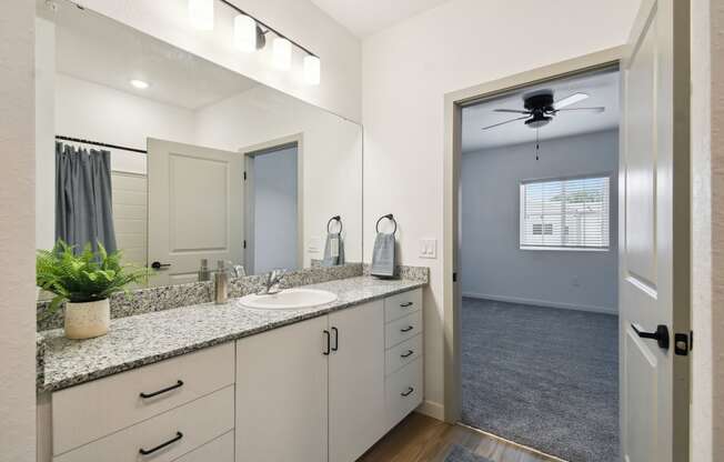 a bathroom with a large mirror and a sink at Gibson Oaks, Lakeland, 33809