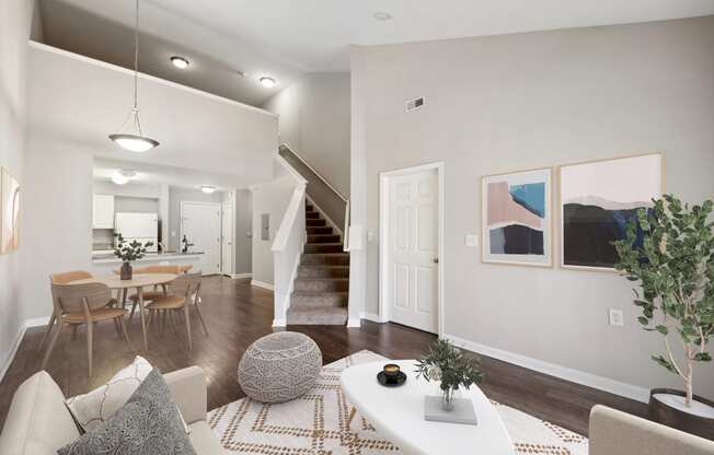 an open living room and dining room with a staircase in a home at MetroPlace at Town Center, Maryland