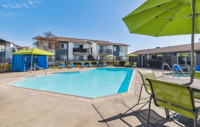 Swimming pool and pool deck with loungers and tables