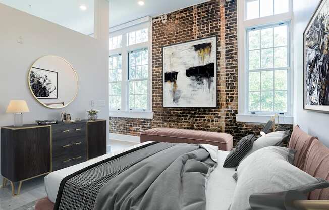 a bedroom with a bed and a brick wall