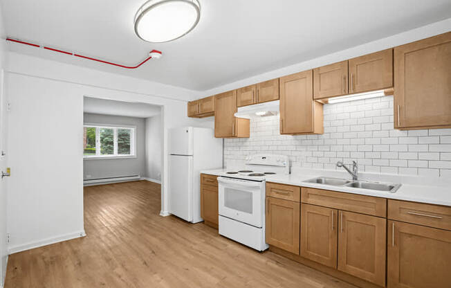 A kitchen with wooden cabinets and white appliances.